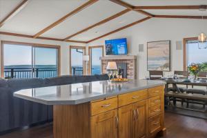 a kitchen with a large island in a living room at Whale Watch FANTASTIC VIEWS Game Room Dog Friendly in Dillon Beach