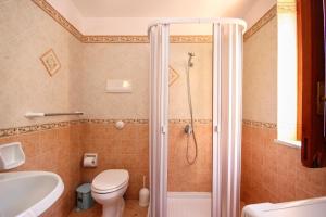 a bathroom with a shower with a toilet and a sink at Casa Buscarini in Santa Flavia