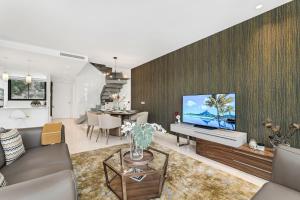 a living room with a couch and a tv at Oasis by the Sea in La Cala de Mijas (La Valvega) in Mijas Costa