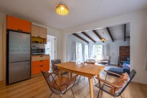 a kitchen and dining room with a wooden table and chairs at 15 Bristol Street in Hanmer Springs