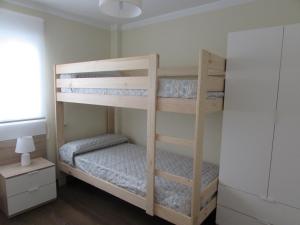 a bunk bed room with two bunk beds in it at Luz y Mar Huelva-Ático in Huelva