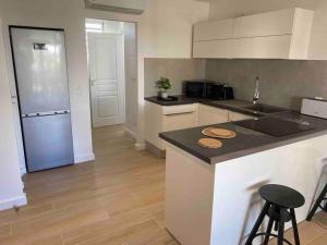 a kitchen with a counter top and a refrigerator at One bedroom Duplex TIT’ HOME Orient bay in Orient Bay