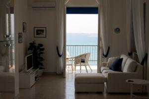 a living room with a couch and a view of the ocean at Atlantis in Trapani