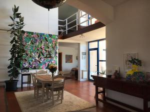 a living room with a table and a painting on the wall at Espacio Shangrila.One in Uceda