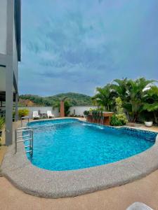 a large swimming pool with blue water in a building at Norshah Village Resort in Pantai Cenang