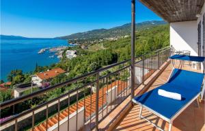 a balcony with blue chairs and a view of the ocean at 4 Bedroom Nice Apartment In Opatija in Opatija