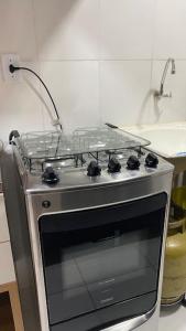 a stove top oven in a kitchen at Brisas do Lago in Paulo Afonso