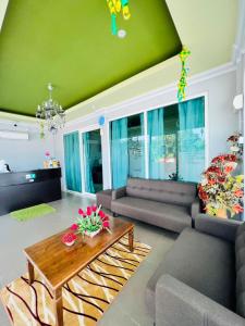 a living room with a couch and a table at Norshah Village Resort in Pantai Cenang +49 photos