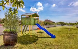 a playground with a slide in a yard at Pet Friendly Home In Valtura With Wifi in Valtura