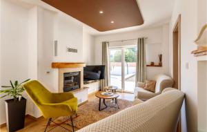 a living room with a couch and a fireplace at Cozy Home In Nova Sela With Outdoor Swimming Pool in Nova Sela
