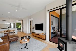 a living room with a couch and a fireplace at The Ridge at Maleny 1 Bedroom Villa in Maleny