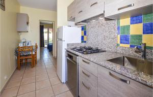 uma cozinha com um frigorífico branco e um lavatório em Stunning Apartment In Propriano With Kitchen em Propriano
