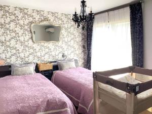a bedroom with two beds and a mirror on the wall at Sparky’s House in Naoshima