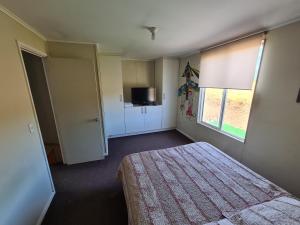a small bedroom with a bed and a window at Casa Rucapillan Villarrica in Villarrica