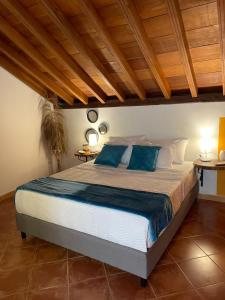 a bedroom with a large bed with blue pillows at Candilejo Hotel Boutique in Cartagena de Indias +54 photos