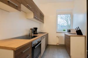 a kitchen with a sink and a stove at Tolstov Apartments - 4 Room Apartments - 30 Min Messe DUS in Duisburg