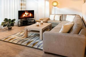 a living room with a couch and a fireplace at Apartment in Wildschönau for nature lovers in Niederau