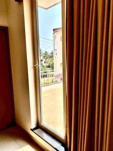 an open window with a view of a street at Kamat's Hilltop Leisure in Dona Paula