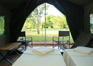 two beds in a tent with a view of a park at Big Game - Wilpattu by Eco Team in Wilpattu