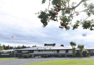 a building with two flags in front of it at Wilderness Backpackers in Haast