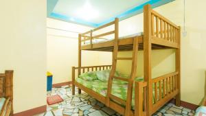 a bunk bed in a room with a ladder at RGV Beach Resort Batangas RedPartner in Calatagan