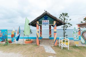 a kiosk on the beach with surfboards at RGV Beach Resort Batangas RedPartner in Calatagan +28 photos