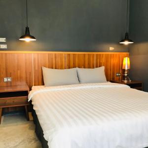 Łóżko lub łóżka w pokoju w obiekcie Kenting Cozy B&B