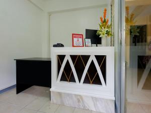 a white cabinet with a wine rack in a room at OYO 840 Orangenest Apartelle in Manila