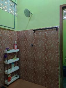 a shower in a bathroom with a wall at Kubang Kerian DECO HOMESTAY Aircond Wifi Netflix in Kota Bharu