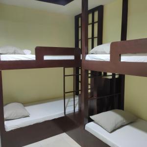 a room with four bunk beds in a dorm at Fiesta Ballroom Hotel in Legazpi