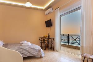 a bedroom with a bed and a balcony at Sitia Old Port studio - 3min walk to beach - AC - WIFI in Sitia