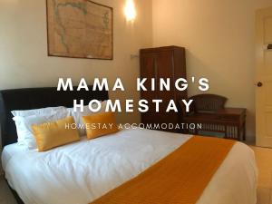 a bedroom with a bed with ahmarma kings at Mama King's Homestay @ Marina Island in Kampong Batu Gajah