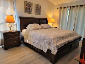 a bedroom with a bed and a nightstand and two lamps at Beautiful townhouse easy access to everything. in Clearwater