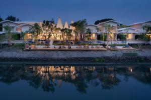 a view of the resort from the water at night at Sala Bang Pa-In in Phra Nakhon Si Ayutthaya