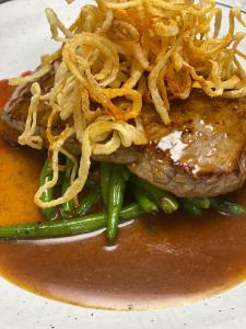 a plate of food with a piece of meat with noodles at Gasthaus Rössle in Nenzing