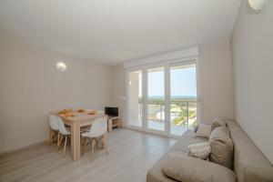 a living room with a couch and a table at Apartment Amazing Island in Povljana
