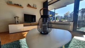 a bird cage sitting on a table in a living room at Black Forest Bergliebe Pool Terrasse Natur Ruhe Komfort in Höchenschwand