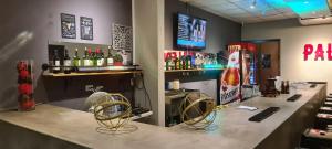 a bar with two chairs and a counter with drinks at Hostal Casa Luna in Santa Ana