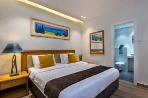 a bedroom with a large bed and a bathroom at Melio Hotel Eilat in Eilat