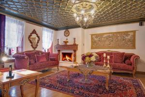 a living room with red furniture and a fireplace at ARCHONTARIKI Historic Boutique Hotel in Ioannina