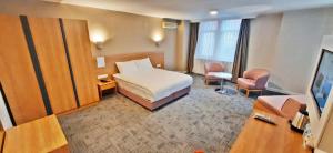 a hotel room with a bed and a television at Silivri Park Hotel in Silivri