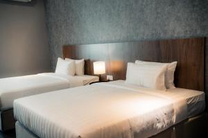 Postel nebo postele na pokoji v ubytování Le'venue Hotel