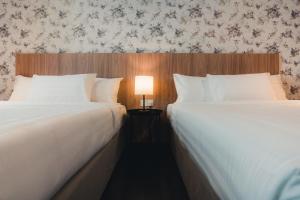 Postel nebo postele na pokoji v ubytování Le'venue Hotel