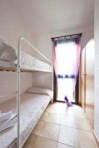 En eller flere senge i et værelse på Villetta Turagri