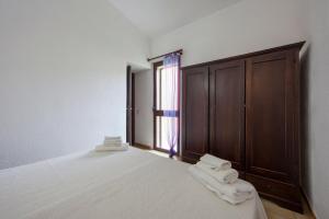 En eller flere senge i et værelse på Villetta Turagri