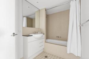 a bathroom with a sink and a shower curtain at NAPI26N - Napier Vistas in Sydney