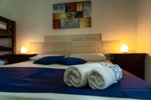a bedroom with a bed with towels on it at Appartamento Asfodelo in Villacidro
