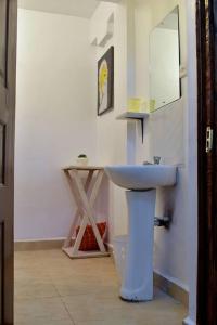 a bathroom with a sink and a mirror at Rorot Spacious one bedroom in Kapsoya with free Wifi in Eldoret +11 photos