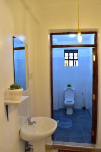 a bathroom with a sink and a toilet at Rorot Spacious one bedroom in Kapsoya with free Wifi in Eldoret