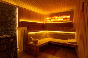 a wooden sauna with a bucket in it at The Dream Getaway & Spa by DeVasco in Bečići